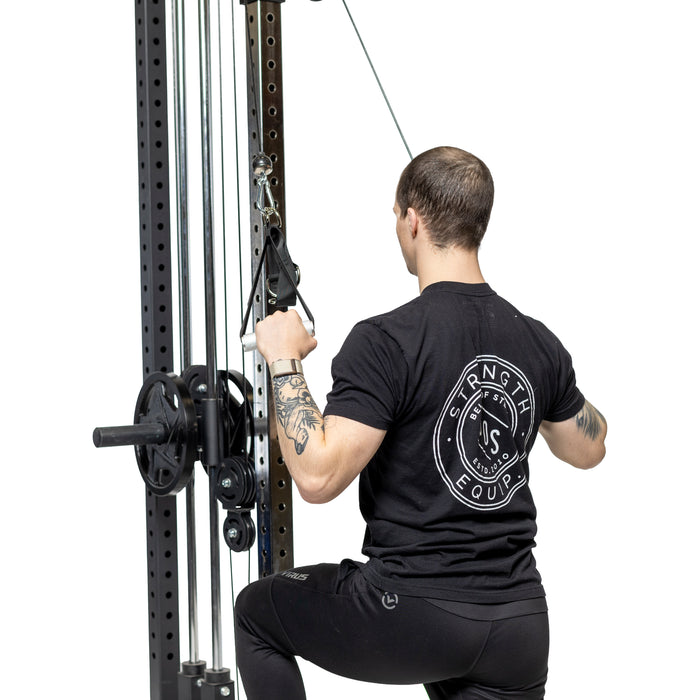 A person in black workout attire kneels on one knee, performing a pulldown with Bells of Steel Adjustable Length Aluminum Handles. The white background highlights these premium gym accessories in action.
