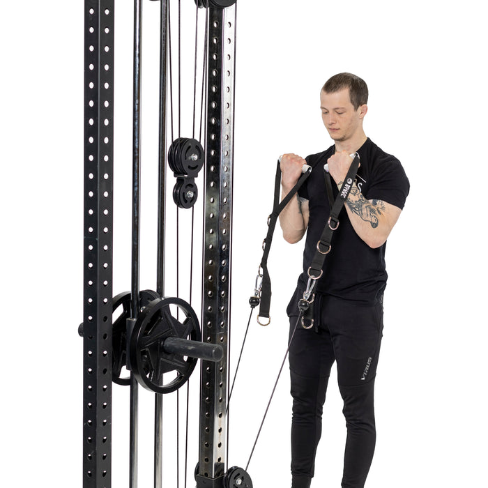 A man in black workout clothes uses Bells of Steel Adjustable Length Aluminum Handles to perform a bicep curl exercise, standing upright against a white background.