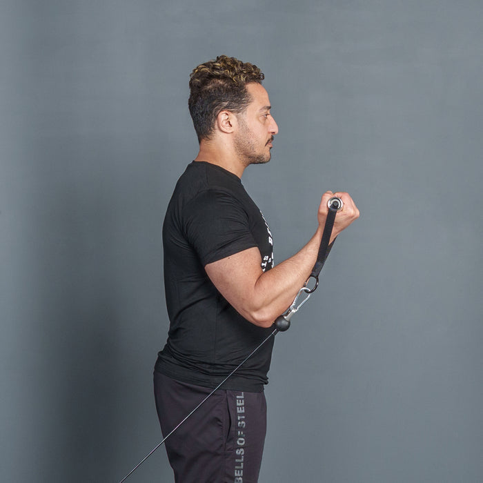 A man in black t-shirt and pants performs a bicep curl with Bells of Steel USA Aluminum Handles Pair with Bearings and resistance bands, standing sideways against a plain gray background.