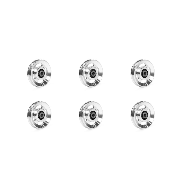 Six aluminum pulley wheels from Bells of Steel are displayed in two vertical columns on a plain white background, featuring a striking black core encased in a shimmering silver rim.