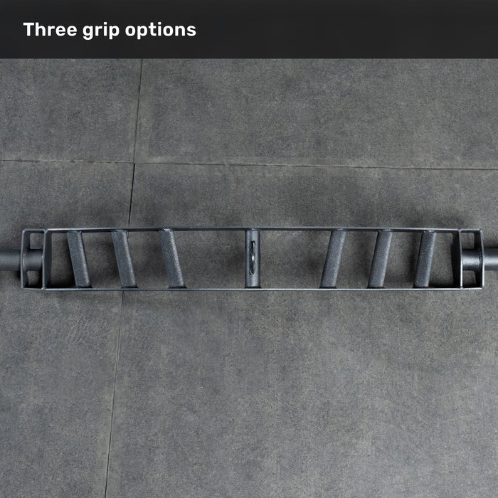 The Bells of Steel Arch Nemesis Swiss Bar, featuring three grip options, rests on a gray tiled floor. "Three grip options" appears in white text—making it an ideal specialty barbell for any bench builder’s collection.
