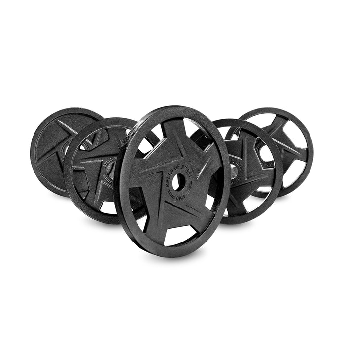 A stack of Black Mighty Grip Olympic Weight Plates by Bells of Steel, arranged upright with slight overlaps, showcases their ergonomic precision grip handles. Made from solid material for easy handling, they're set against a plain white background.