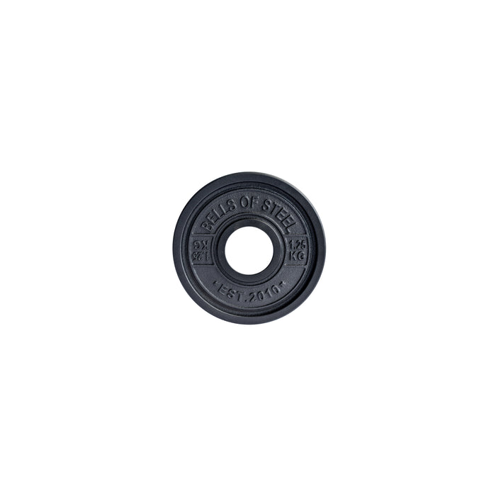 A black Bells of Steel Calibrated Powerlifting Plate, designed to IPF specifications, features a center hole with "BELLS OF STEEL" on top, "1.25 KG" on the right, and "EST. 2010" below.