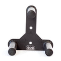 The Bells of Steel Change Plate Storage Pegs is a black metal wall mount bracket with three cylindrical pegs arranged in a triangle, ideal for organizing Olympic change plates. It features two mounting holes and an upside-down "SIS" logo at the bottom.