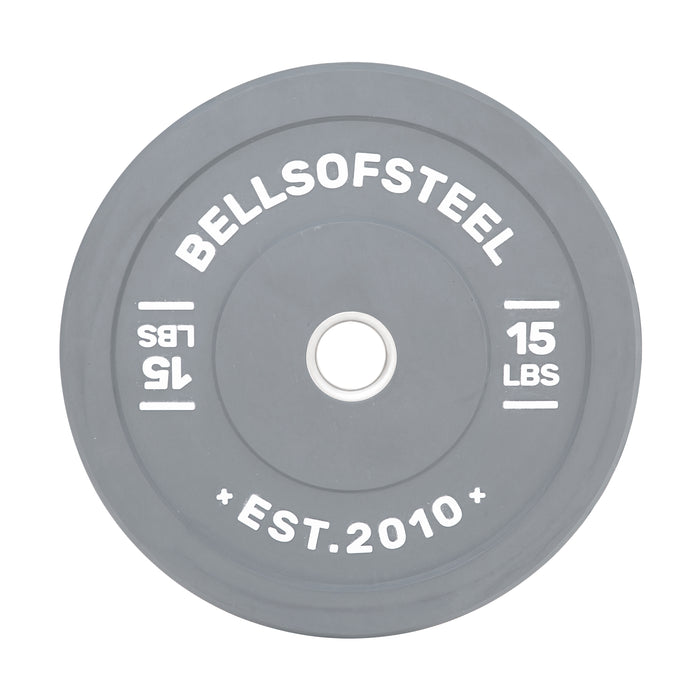 A gray Bells of Steel "Colored Bumper Plates" features a stainless steel insert, printed with "BELLSOFSTEEL," "15 LBS," and "EST. 2010." A lighter gray circle surrounds the center hole for accuracy.