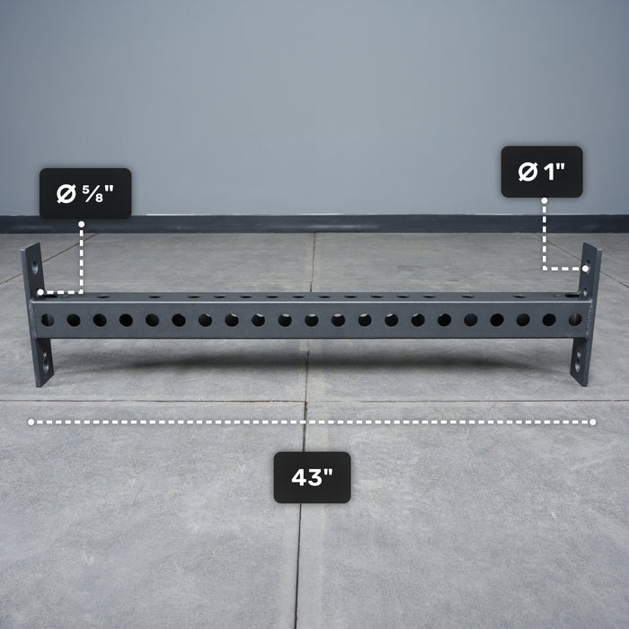 The Bells of Steel USA Crossmember For Converter Bench - 43" is displayed on a tiled floor, featuring evenly spaced holes with diameters of 5/8 inch and 1 inch along its 43-inch length.