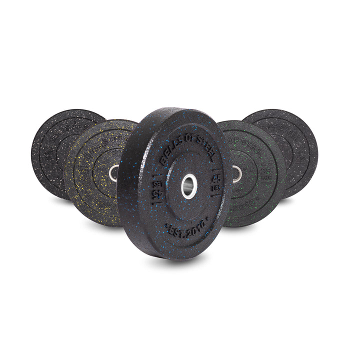 A set of Bells of Steel Crumb Bumper Plates with colored speckles and white centers is staggered from smallest to largest, displaying weights like 15 kg and 25 kg. These plates add texture to your lifting routine.