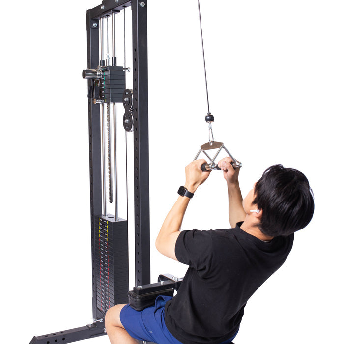 Wearing a black shirt and blue shorts, a person uses the Bells of Steel Double D Handle Cable Attachment on a seated cable row machine, gripping it firmly against a white background.