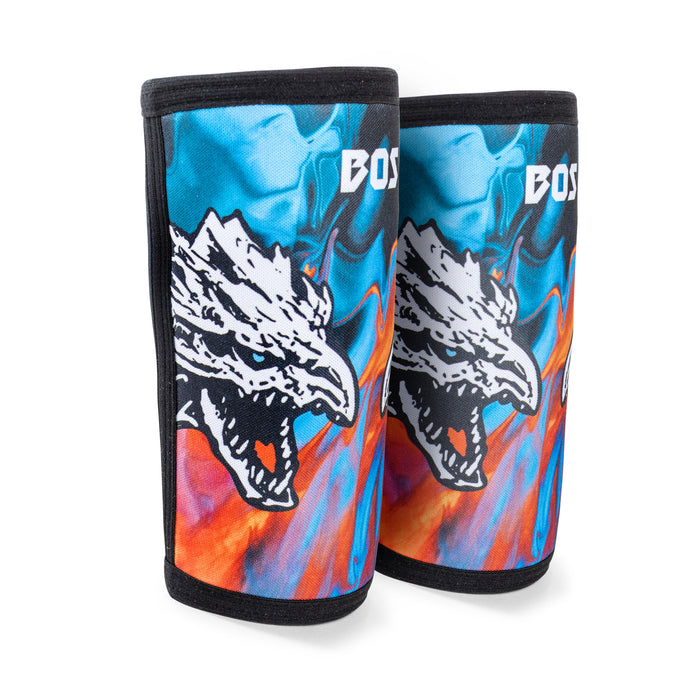 Bells of Steel Elbow Sleeves feature a fierce white dragon head on a vibrant blue and orange background, bold white text at the top, and provide both compression support and eye-catching style.