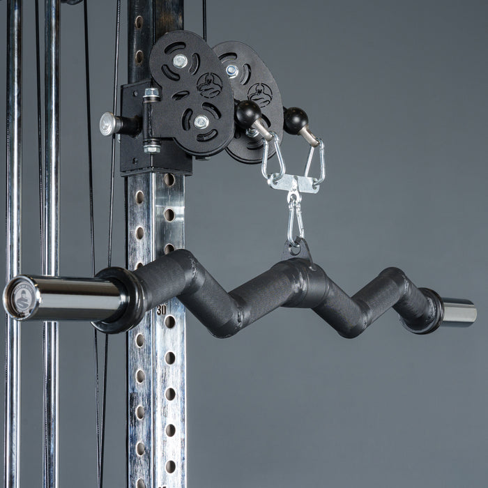 Close-up of the Bells of Steel Fat Bar - Olympic Curl Bar Cable Attachment, a black zigzag bar on a pulley system, designed to enhance grip strength. Set against a plain gray background.