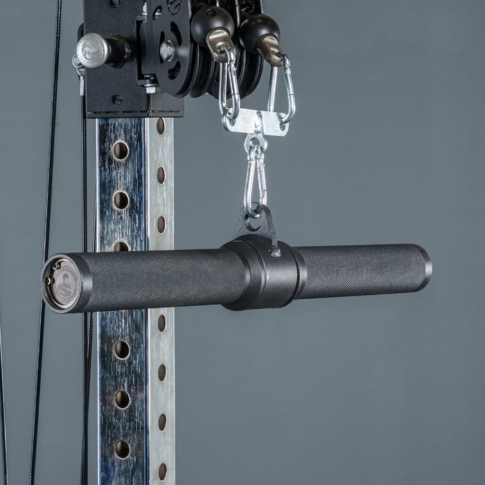 A close-up of the Bells of Steel Fat Bar - Straight Handle Bar, a black textured cable machine attachment, connected to a weight machine pulley system against a gray background.