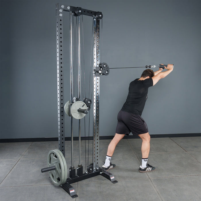 A man uses the Bells of Steel Fat Bar - Tricep Pressdown on a cable machine, improving grip strength in a gym with gray walls and a concrete floor.