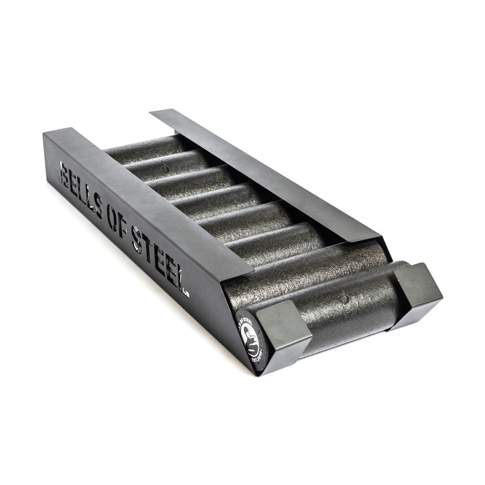 The Bells of Steel Foam Roller Storage is a black metal rack with "BELLS OF STEEL" cut out on the side, ideal for organizing foam rollers and bars to keep your gym space streamlined and tidy.