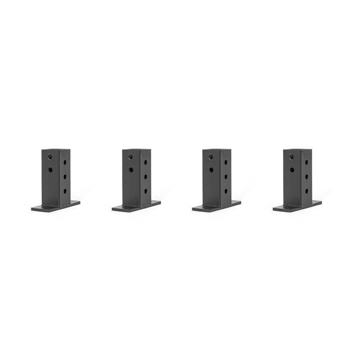 Against a white background, four black rectangular metal brackets from Bells of Steel's Folding Rack Wall Connectors & Hinges are evenly spaced. Each bracket is designed with multiple circular holes for easy wall mounting or attaching.