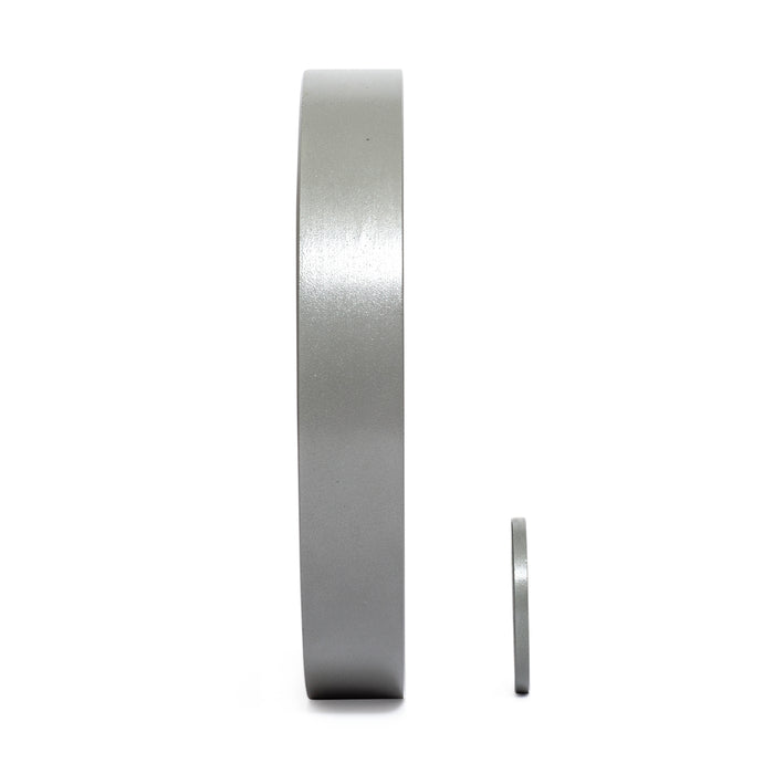 Two Gray Mighty Grip Olympic Weight Plates by Bells of Steel stand on a white background. The larger plate with precision grip handles is on the left, exuding elegance, while the smaller plate is on the right, both viewed from the side.