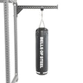 A black heavy bag from Bells of Steel USA hangs from a chain attached to a sturdy metal support frame, making this Heavy Bag Set an ideal addition to any power rack or gym setup, displayed against a white background.