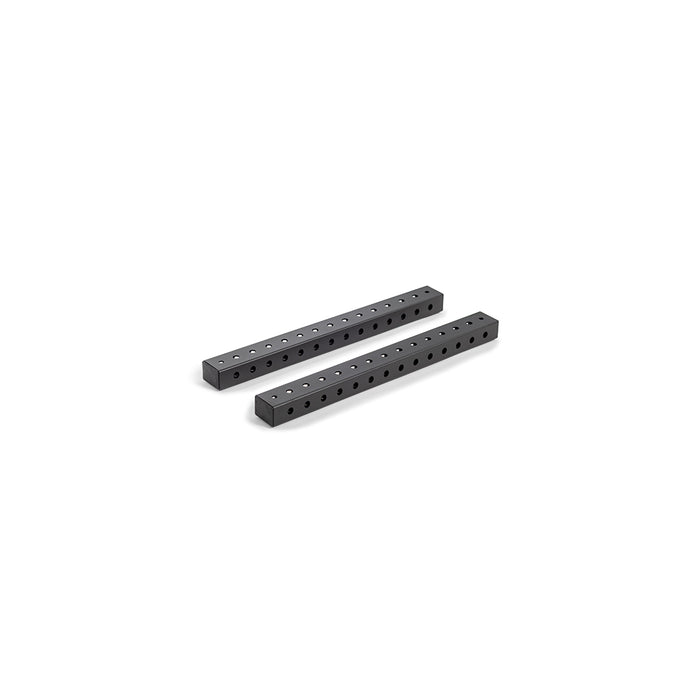 Two Hydra Flat Foot Components by Bells of Steel, black rectangular metal bars with evenly spaced holes, lie parallel on a white background.