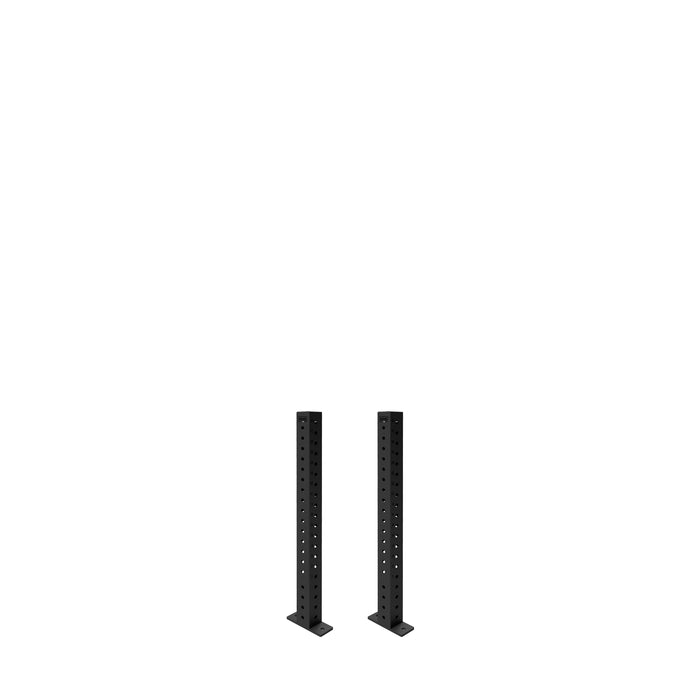 Two black Hydra Vertical Uprights by Bells of Steel, built for a 3x3 power rack, stand parallel on flat bases with multiple holes, ready for various rack attachments against a plain white background.