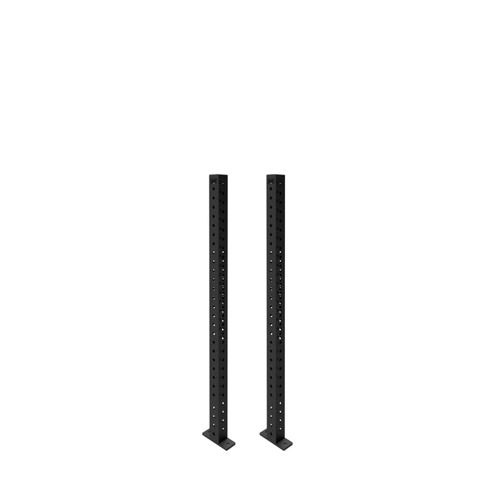 Two Bells of Steel Hydra Vertical Uprights, black with evenly spaced holes and wide base plates, stand side by side against a white background, designed for compatibility with various power rack attachments.