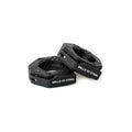 Two black, hexagonal Magnetic Clamp Collars from Bells of Steel, with the brand name printed in white on the sides, are displayed on a white background—one lies flat while the other leans against it.