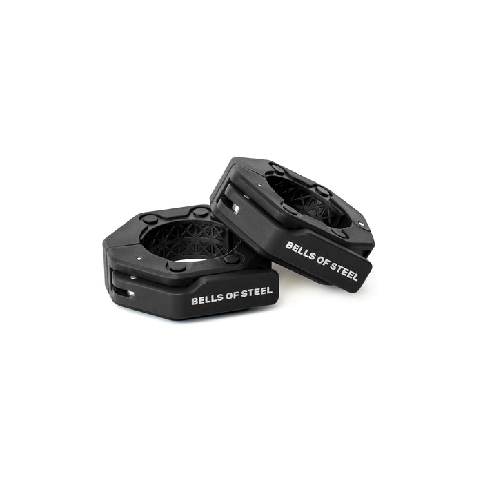 Two black, hexagonal Magnetic Clamp Collars from Bells of Steel, with the brand name printed in white on the sides, are displayed on a white background—one lies flat while the other leans against it.