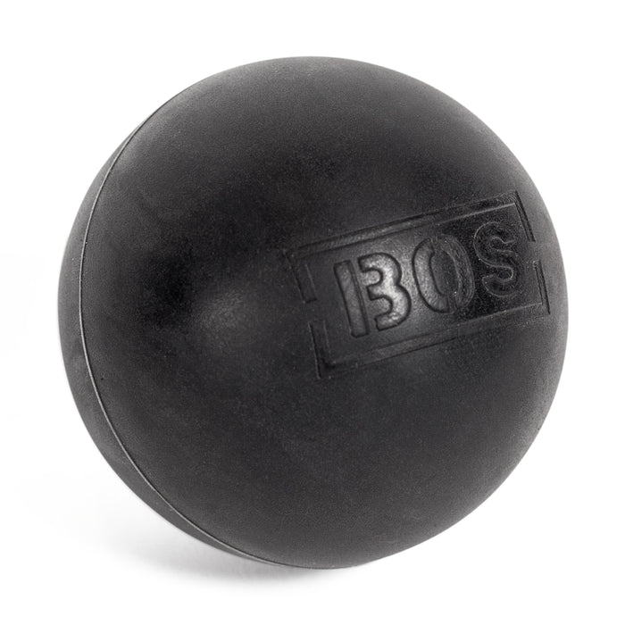 A black Bells of Steel massage ball featuring textured "BOS" lettering rests elegantly on a white background. This versatile tool enhances muscle massage, offers targeted relief, and improves flexibility.