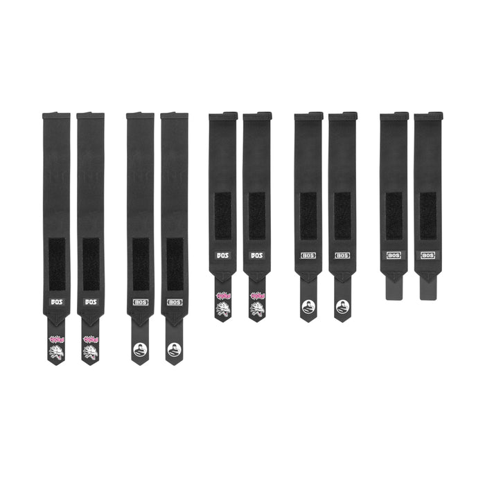 Nine Bells of Steel Mighty Wrist Wraps, made of black nylon with Velcro fasteners and branded labels, are lined up on a white background. These wraps offer wrist support and style—perfect for powerlifting essentials.