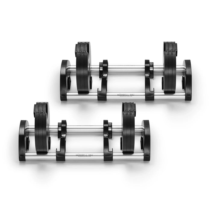Two Nuobell NÜOBELL 50 to 80 LB Expansion Kit - Standard (Chrome) adjustable dumbbells with sleek black weights and chrome handles rest side by side on matching racks against a white background—an ideal choice for anyone seeking to upgrade their adjustable dumbbells or expand their home gym with a versatile 50 to 80-pound range.