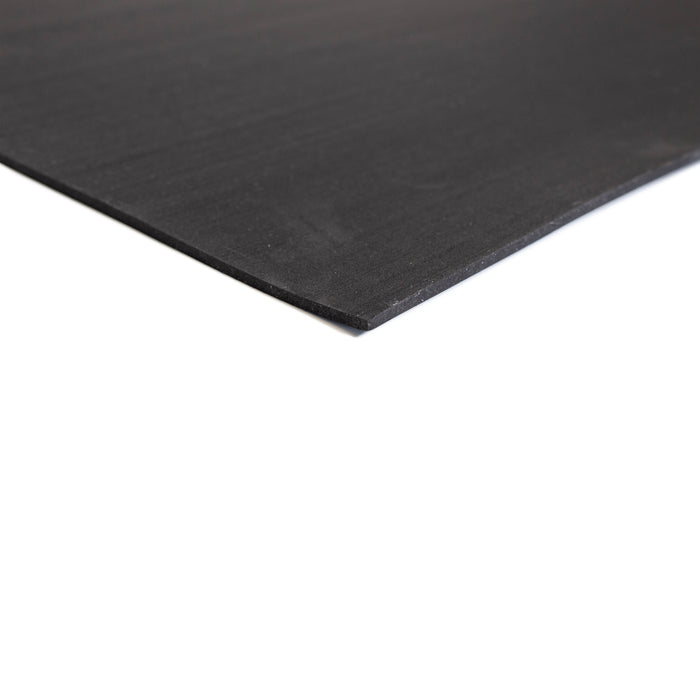 A close-up of the corner of the Bells of Steel Premium Rubber Flooring 4' x 6', a durable, thin black mat—ideal for recycled rubber flooring or heavy-duty gym use—shown against a white background.