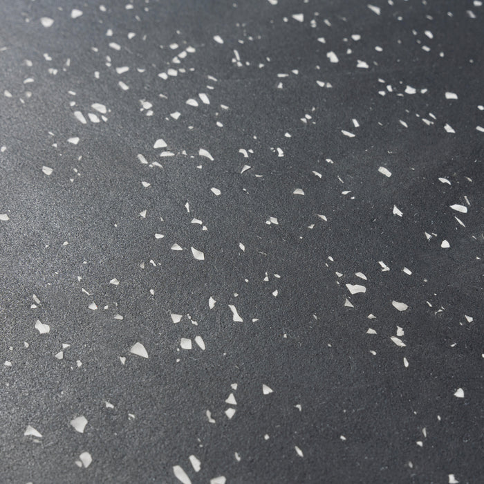 Close-up of the Bells of Steel USA Rubber Flooring Gym Mat 24" x 24" (Set of 2), featuring a dark gray surface with irregular white specks, resembling recycled rubber tiles for heavy-duty gym or fitness flooring.