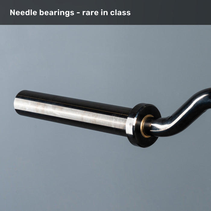 A close-up of Bells of Steel’s Safety Squat Bar - The SS4 shaft and sleeve on a grey background, with text: "Needle bearings – rare in class. Perfect for intense leg day or barbell squats.