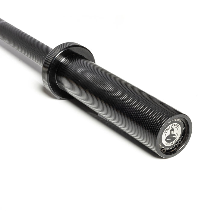 A close-up of the black, grooved sleeve and end cap of a Bells of Steel Short Utility Barbell on a white background. The end cap displays branding and specs in black and silver, making it ideal for any home gym setup.