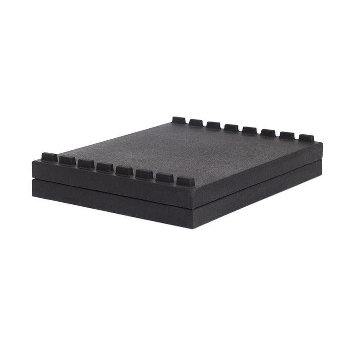 The Bells of Steel Stackable Pull Blocks are black, rectangular foam pads featuring raised square notches and a tongue and groove design, shown stacked together against a white background.