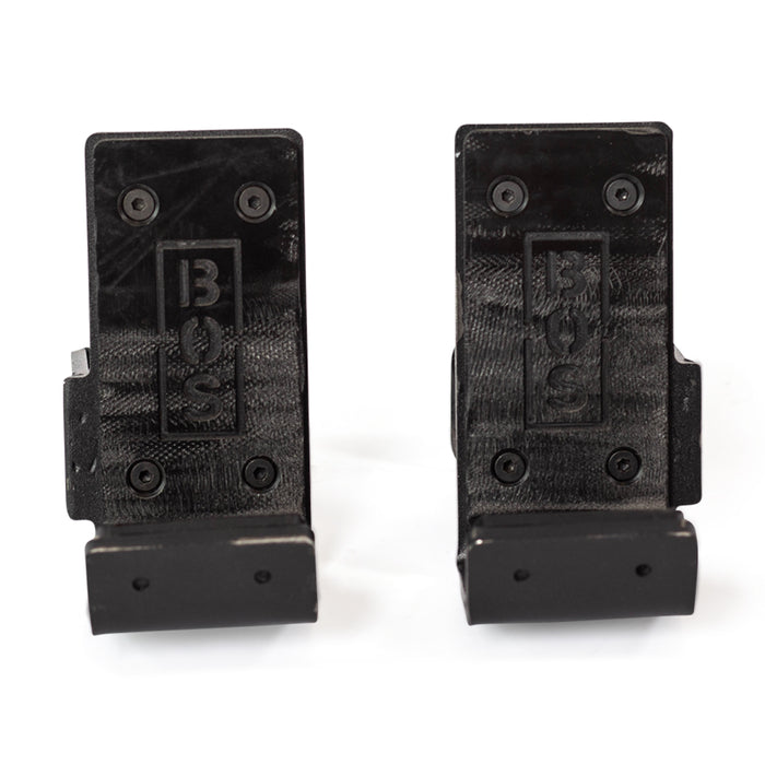 Two black Standard J-Cups by Bells of Steel, each with "BOS" embossed vertically. Each wall-mounted bracket is secured by four screws and features an angled platform at the bottom for extra UHMW protection.
