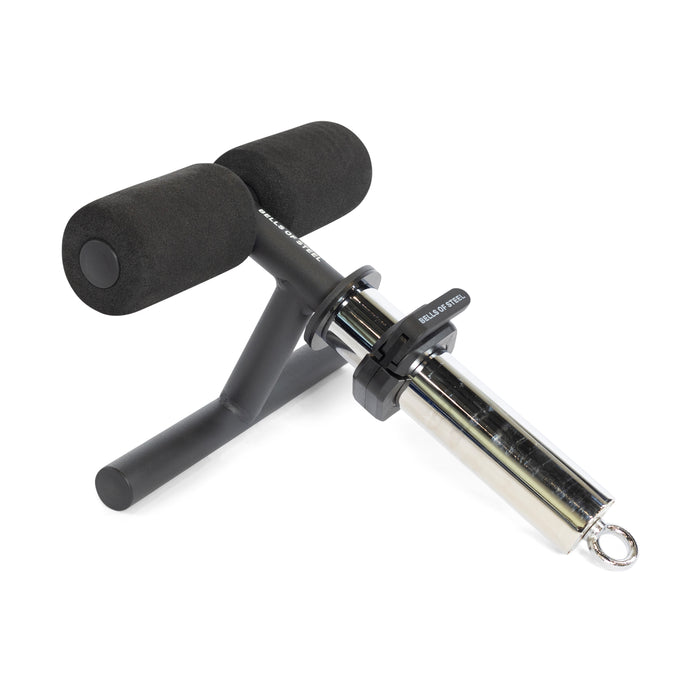 The Bells of Steel Tibialis Trainer Bar features foam rollers and a cylindrical attachment to anchor feet or legs during sit-ups or strength training, helping with workouts and knee injury prevention.