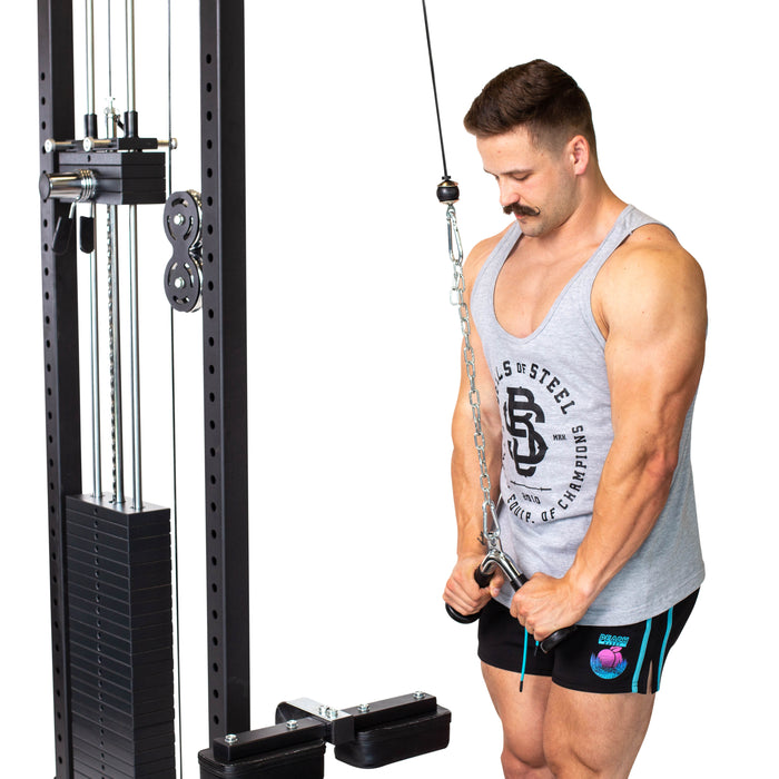 A man performs the Bells of Steel Tricep Pressdown With Ergo Handgrips, wearing a gray tank top and black shorts, using both hands on the cable machine.