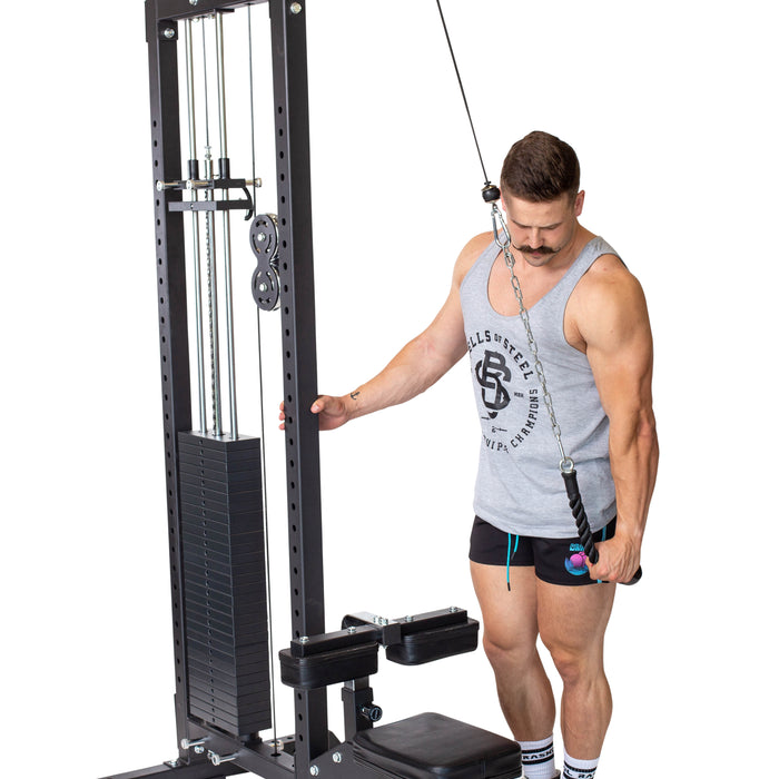 A man in a gray tank top and black shorts uses the Bells of Steel Tricep Pulldown Rope – Single for a one-handed tricep pushdown on a cable machine, standing beside the equipment against a white background.