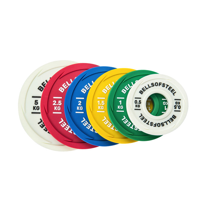 A set of six Bells of Steel Urethane-Coated Change Plates in bright colors, ranging from 0.5 kg to 2.5 kg, displayed side by side with each plate’s weight clearly marked for quick identification during workouts.