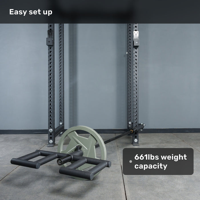 A Bells of Steel Viking Press Attachment with two large wheels is set up indoors near a power rack. Overlay text reads "Easy set up" and "661lbs weight capacity.