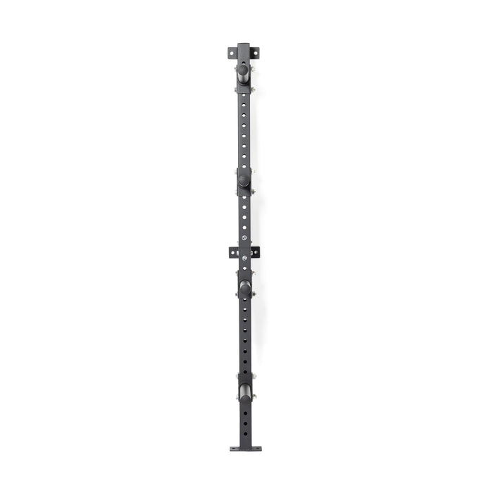 The Bells of Steel Wall-Mounted Plate Storage Rack is a long black metal bracket with multiple holes and four adjustable knobs, ideal for organized home gym storage and designed to be mounted vertically on the wall.