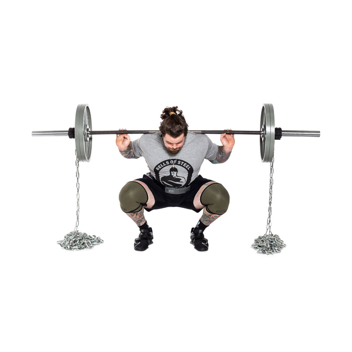A lifter in a grey Bells of Steel shirt and black shorts, showing tattoos on their arms and legs, squats with a barbell and progressive resistance using Bells of Steel Weightlifting Chains. They also wear knee sleeves.